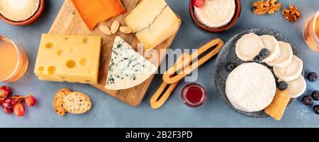 Cheese panoramic flat lay. Blue cheese, Brie, Emmental, goat cheese, and others, shot from the top Stock Photo
