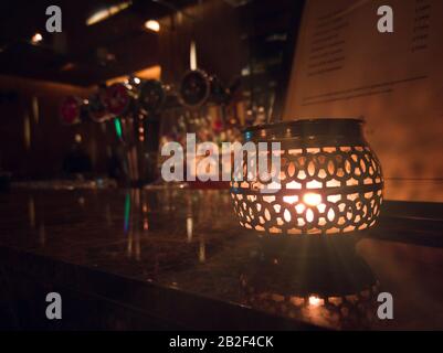 Beautifully lit lamp on a decorated table Stock Photo