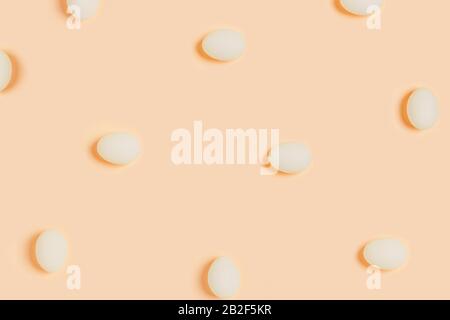 Happy Easter. White eggs on yellow background. Flat lay, top view, copy space. Stock Photo
