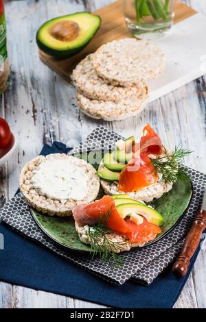 salted salmon fillet with crispbread and avocado. Aromatic herbs, spices and vegetables - healthy food, diet concept. cherry tomato. superfood, open s Stock Photo