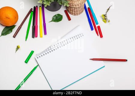 Set of felt tip markers in different colors and a blank sketchbook with a space for text Stock Photo