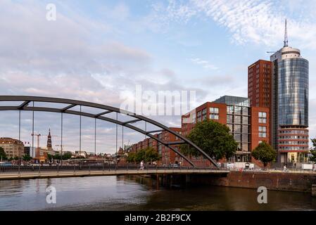 Hamburg, Germany - August 4, 2019: View of the Uberseebrucke bridge over Niederhafen canal in the Hafencity during the sunset in summer.