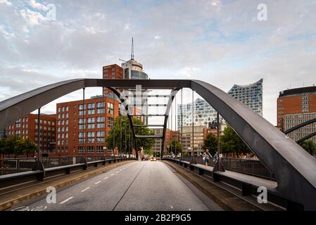 Hamburg, Germany - August 4, 2019: View of the Uberseebrucke bridge over Niederhafen canal in the Hafencity during the sunset in summer.