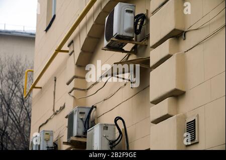 Air conditioners mounted on the wall of building, outdoor shot Stock Photo