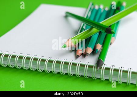 Heap of pencils on a bright green background Stock Photo