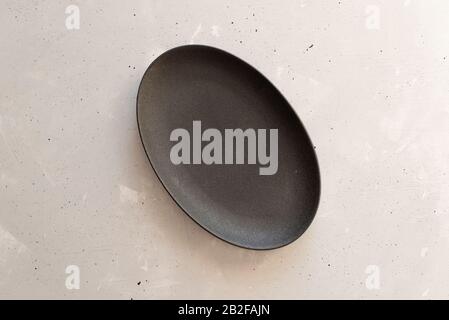 Empty plate on grey wooden table. Stock Photo