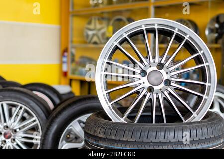 New silver mag wheel. Magnesium alloy car wheels and pneumatic tires in store or service center Stock Photo