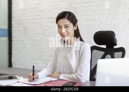 Woman doing office work Beijing China Stock Photo