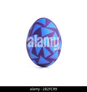 Single purple vertical easter egg with abstract geometric pattern of blue triangles isolated on white background Stock Photo