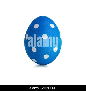 Single vertical easter egg painted with blue paint with a pattern of white circles isolated on a white background Stock Photo