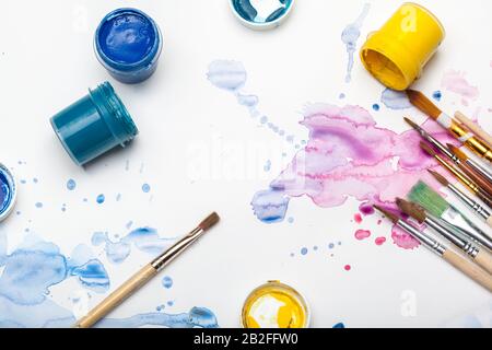 splashes of watercolor paint and painting supplies Stock Photo