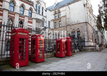 a line of four old red British telephone boxes in London, England. Stock Photo