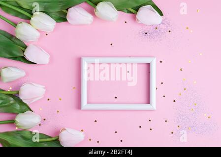 Congrats card with photo frame and corner border from white tulips flowers on a light pink background. Stock Photo