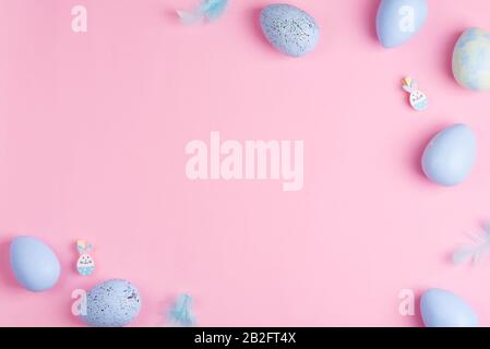 Beautiful Easter pastel blue eggs on pink background with copy space Stock Photo