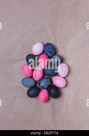 A group of eggs laid out in the shape of a large egg on craft paper. Easter Concept Stock Photo