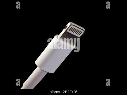 Barcelona, Spain - Feb. 2020: Lightning connector isolated. The plug is compatible with Apple devices like iPhone, iPad, iPod or AirPods. Stock Photo