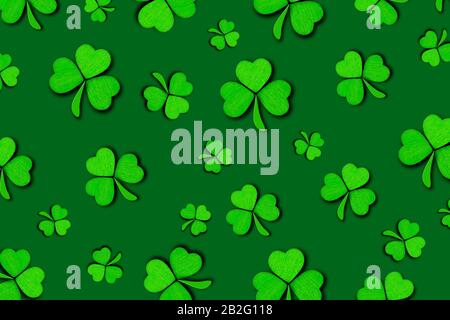 Pattern of green clovers or shamrocks isolated on green background. St. Patrick's Day Holiday concept. Spring background. Stock Photo