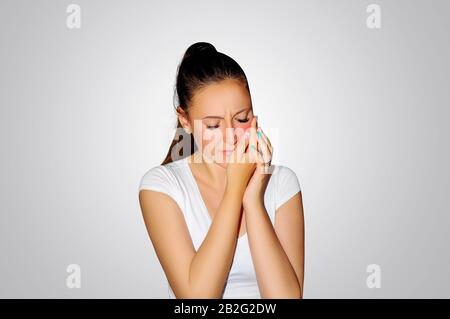 Toothache. Teeth problem. Closeup of beautiful sad girl suffering from strong tooth pain. Dental health and care concept. Stomatology Stock Photo