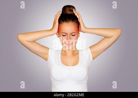 Health and pain. Young woman having strong tension headache. Closeup portrait of beautiful sick girl suffering from head migraine, feeling pressure Stock Photo