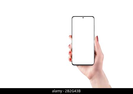 Modern smart phone mockup in woman hand isolated. Soft light on retouched woman hand with red nails. Camera built into the display Stock Photo