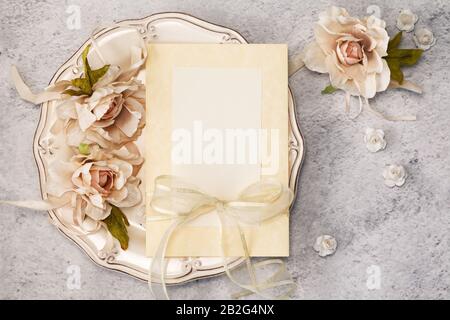 Elegant festive table setting with blank card in restaurant. Menu Invitation mockup. Stock Photo