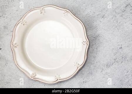 Empty plate fork and knife on table. Stock Photo