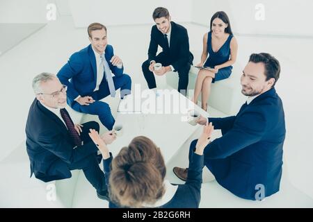 Team of company managers discussing plans during office meeting Stock Photo