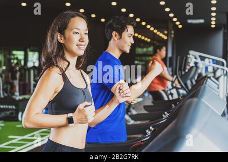 Couple young diversity working out in gym fitness sport complex, workout working out running and cardio, posture position, sports and healthcare conce Stock Photo