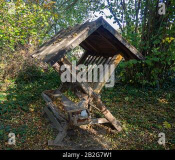 Feed manger for wild animals in a small clearing in the forest Stock Photo