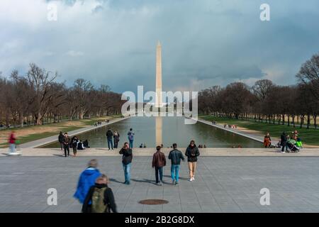 New York, USA - MAR 2019 : Unrecognizable various tourists are visiting the Abraham Lincoln Memorial which can see washington monument on March 22, 20 Stock Photo