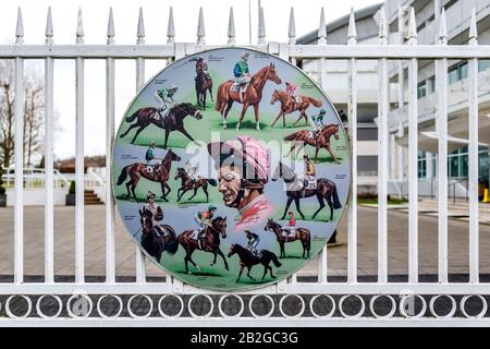 A tribute to the champion jockey Lester Piggott on gates at Epsom Downs racecourse. The artwork shows his many Derby, Oaks and Coronation cup winners. Stock Photo