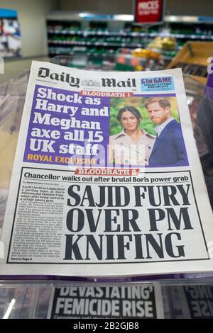 Daily Mail newspaper headlines 'Harry and Meghan axe all 15 UK staff' 'Sajid Fury over PM Knifing' on supermarket newsstand 14 February 2020 London UK Stock Photo