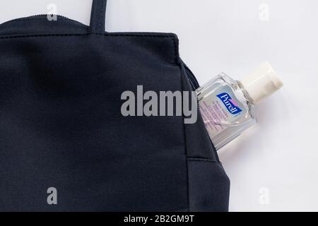 Bottle of Purell hygienic hand rub, hand gel, hand sanitiser, in handbag Stock Photo