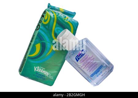 Bottle of Purell hygienic hand rub, hand gel, hand sanitiser with packet of Marque Kleenex brand tissues balsam + menthol tissues isolated on white Stock Photo