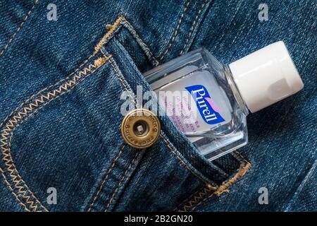 Bottle of Purell hygienic hand rub, hand gel, hand sanitiser, in pocket of Red Herring denim jacket Stock Photo