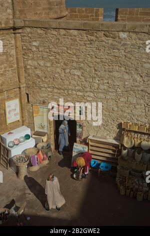 Craft shops and tourists at the fort ramparts by the Atlantic Ocean in Essaouira,Morocco Stock Photo