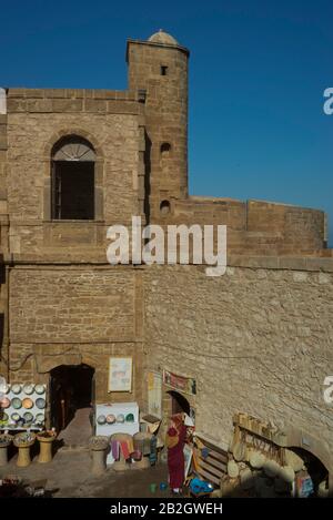 Craft shops and tourists at the fort ramparts by the Atlantic Ocean in Essaouira,Morocco Stock Photo