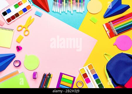 School supplies lay out with colorful stationery. Markers, color pencils, notebooks, top view Stock Photo