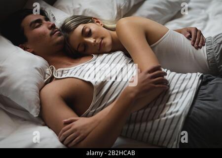 Young couple sleeping together in the bed Stock Photo