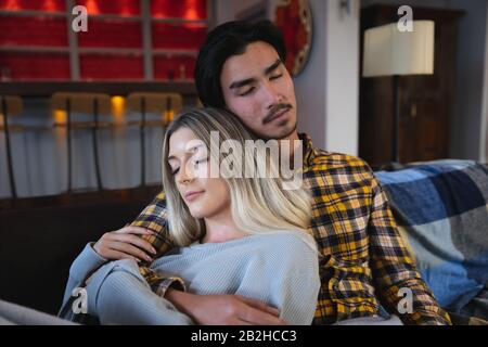 Young couple sleeping together on the sofa Stock Photo