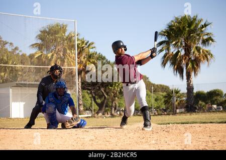 Baseball player hitting a ball during a match Stock Photo