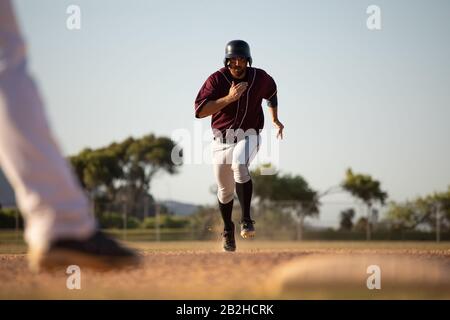 Baseball player running to a base during a match Stock Photo