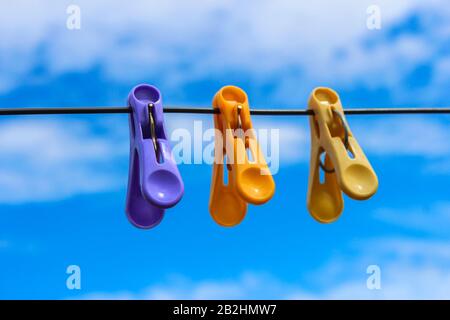 Linen clothespins on the wire for drying clothes against the sky Stock Photo