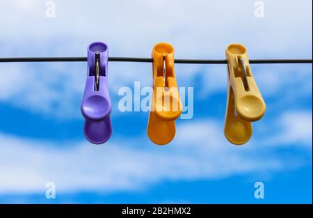 Linen clothespins on the wire for drying clothes against the sky Stock Photo