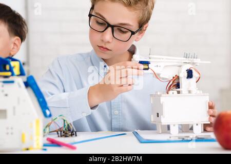 Stem education. Boy testing his new robotic device Stock Photo