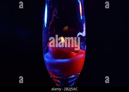 Candle after blowing out the flame photographed with colorful flashes in the studio Stock Photo