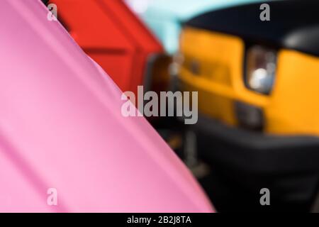 Two small cars of different colors on the road Stock Photo