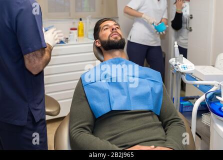 Male patient in the dentist's chair ready to be operated. Stock Photo