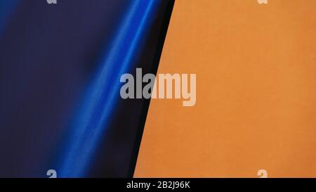 Blue fabric on painted wall background Stock Photo