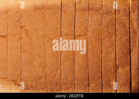 Sliced brown bread  close up view background. Wheat toast theme Stock Photo